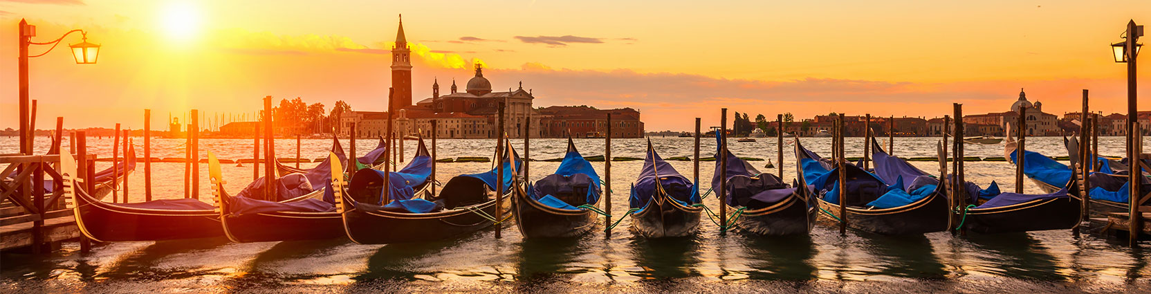 Gondola on a Venetian canal at sunset.